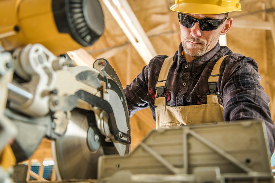 Specialized Business Insurance - Construction Contractor at Work Using A Bandsaw